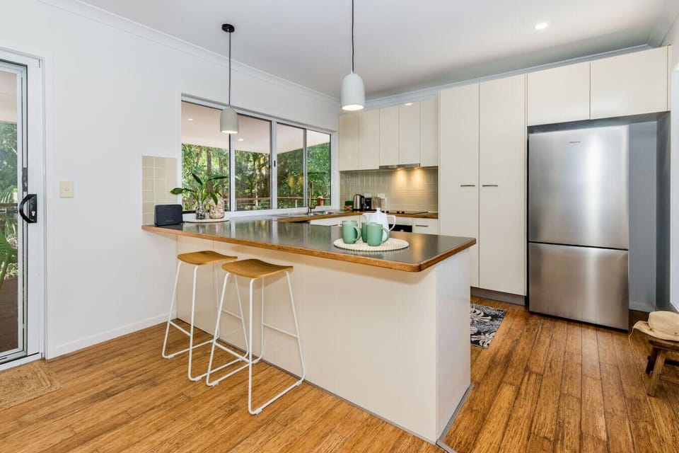 Spacious kitchen with island seating, modern appliances, and plenty of light—ideal for family meals.