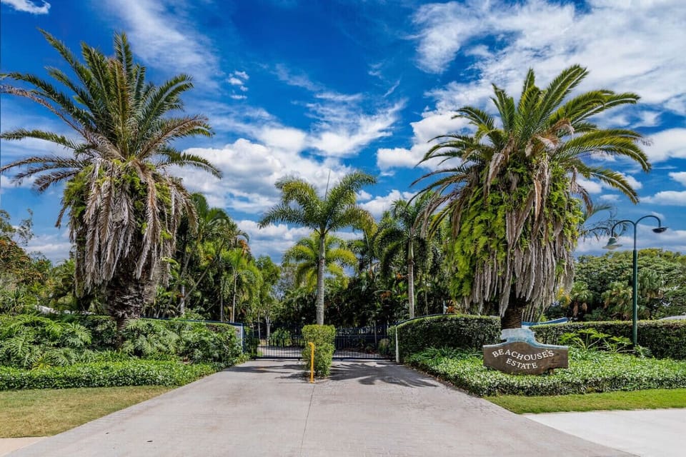Welcoming estate entrance with tropical landscaping and gated access—ideal for family stays.