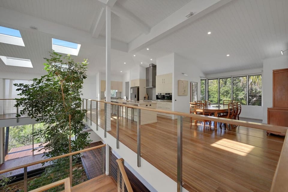 Bright family space featuring kitchen, dining area, and unique indoor greenery for a warm, inviting stay.