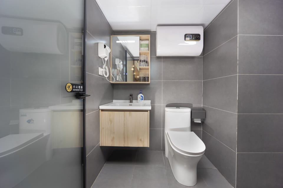 Family Suite, City View | Bathroom | Shower, hair dryer, slippers, towels