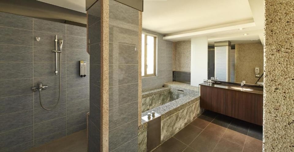 Deluxe Balcony Room | Bathroom | Hair dryer, slippers, towels, soap