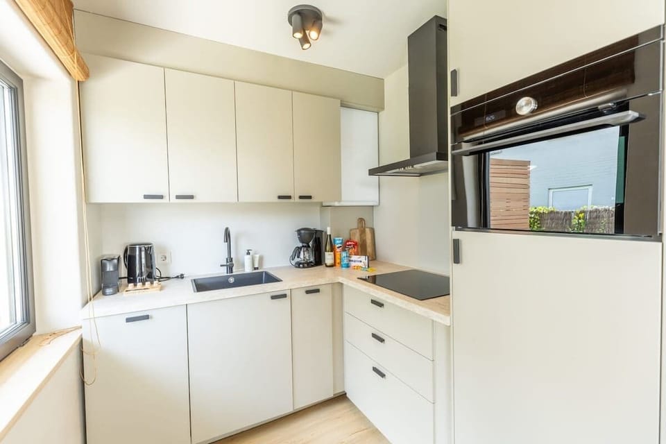 Modern and fully-equipped kitchen, perfect for preparing your favorite meals during your stay. Enjoy sleek, minimalist design with all the essentials at your fingertips.