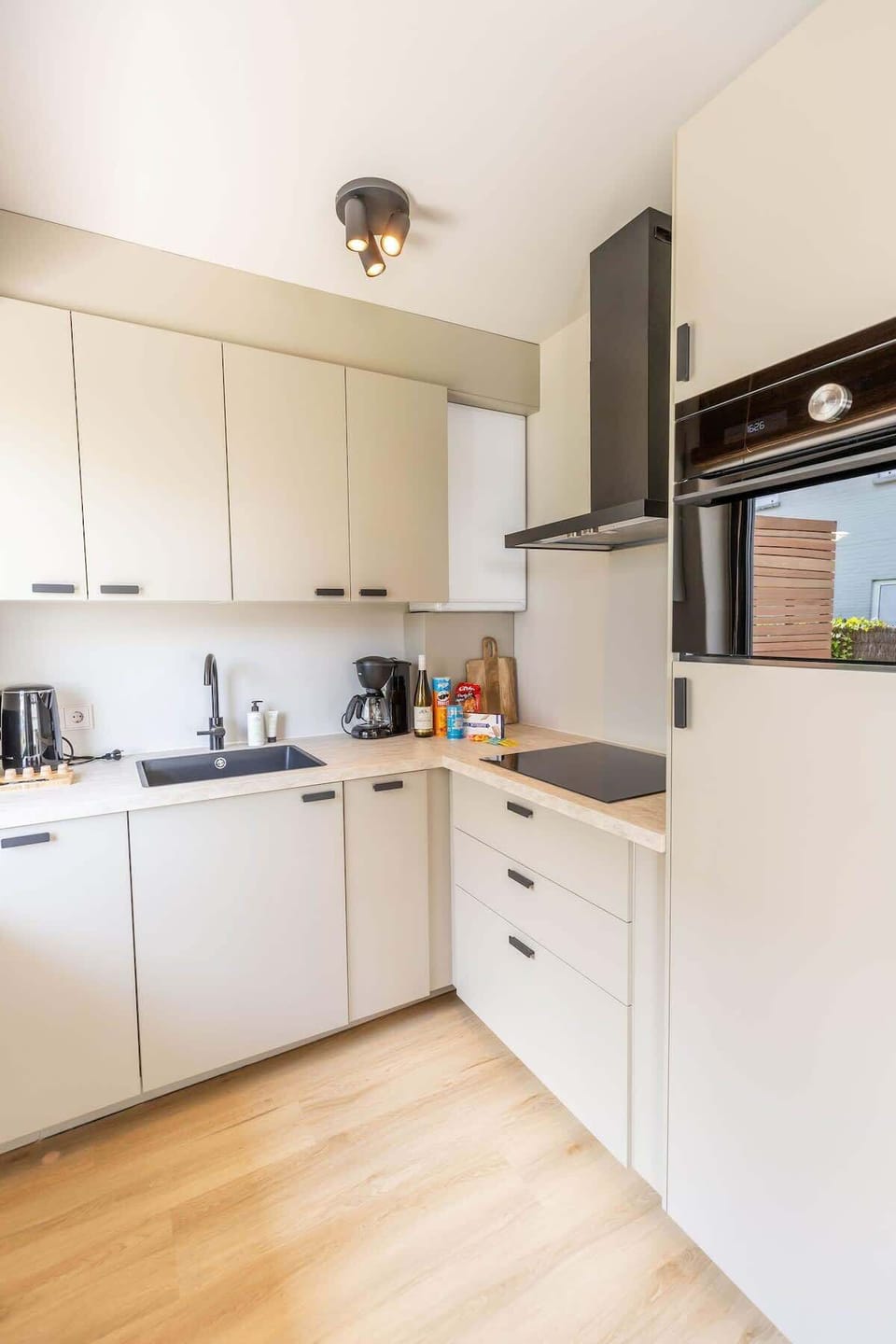 Modern and fully-equipped kitchen, perfect for preparing your favorite meals during your stay. Enjoy sleek, minimalist design with all the essentials at your fingertips.