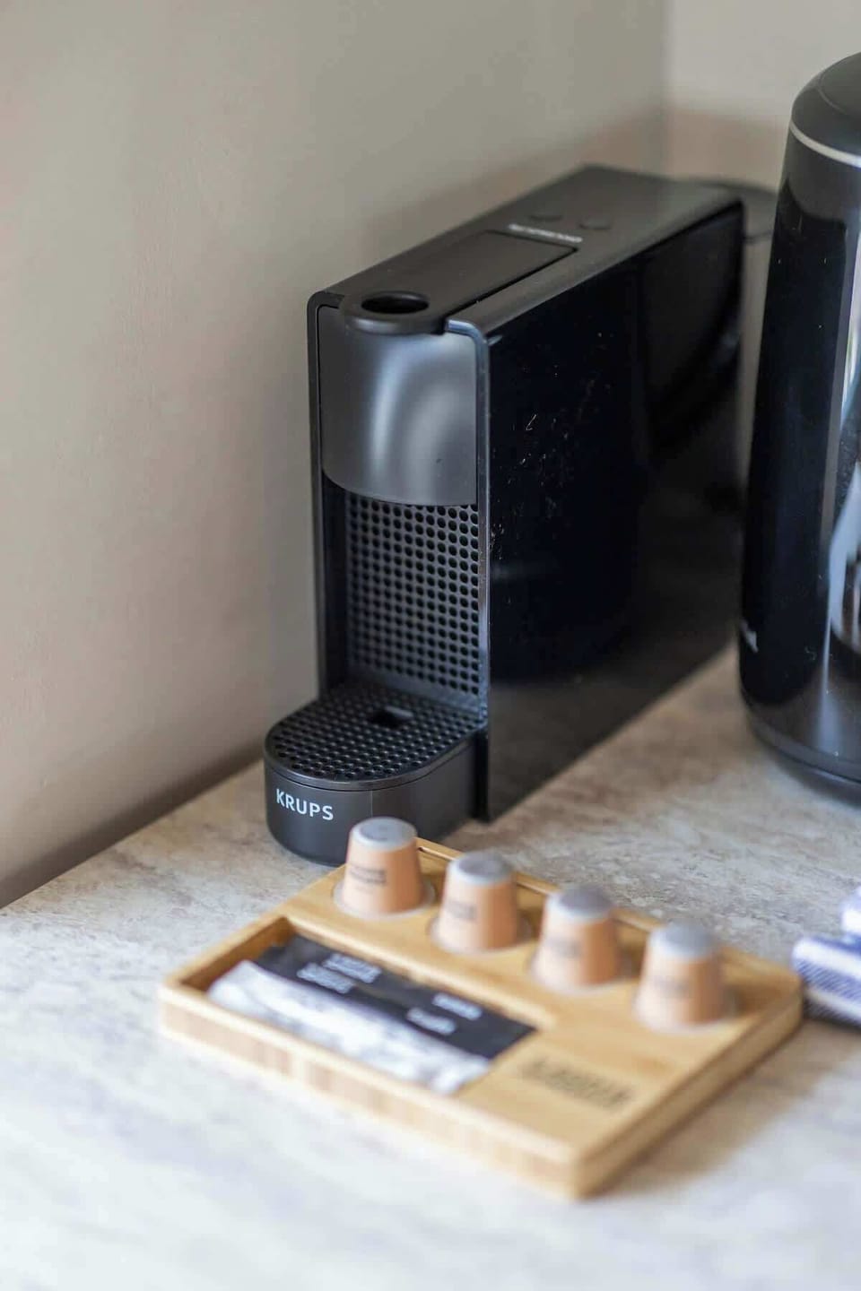 "Start your mornings right with a stylish coffee machine and a selection of coffee pods, ensuring a fresh cup whenever you need it.
