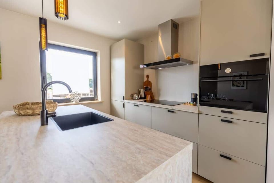 Enjoy a stylish open-plan kitchen with modern appliances, ample storage, and a central island perfect for cooking or socializing.