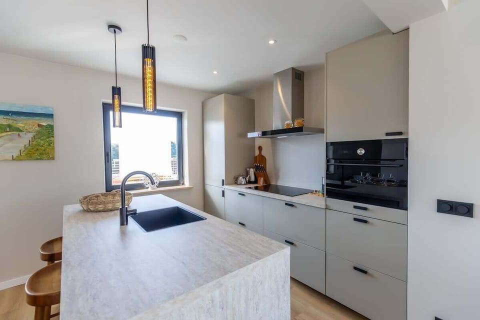 Let natural light flood the modern kitchen, designed with clean lines, soft tones, and all the essentials for home cooking.