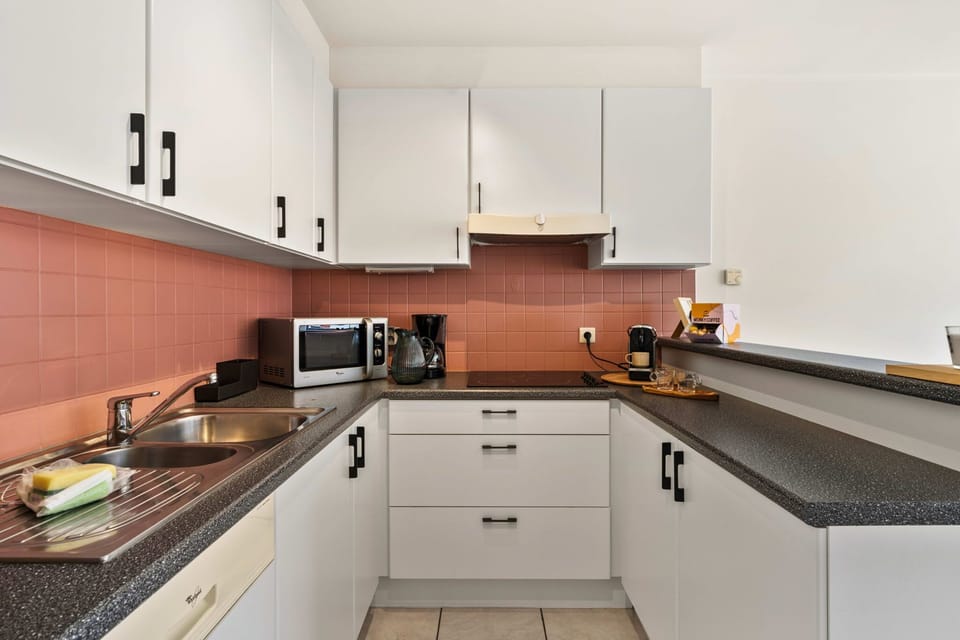 Well-equipped kitchen with stove, microwave, coffee maker, and dishwasher