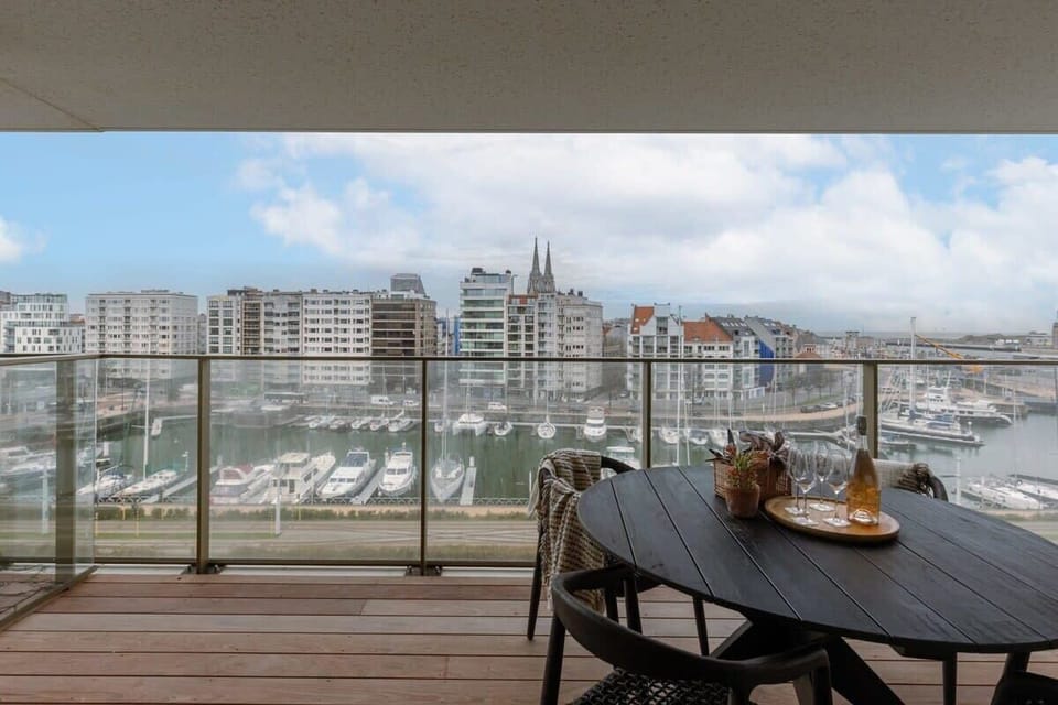 Modern balcony with marina views and outdoor dining setup