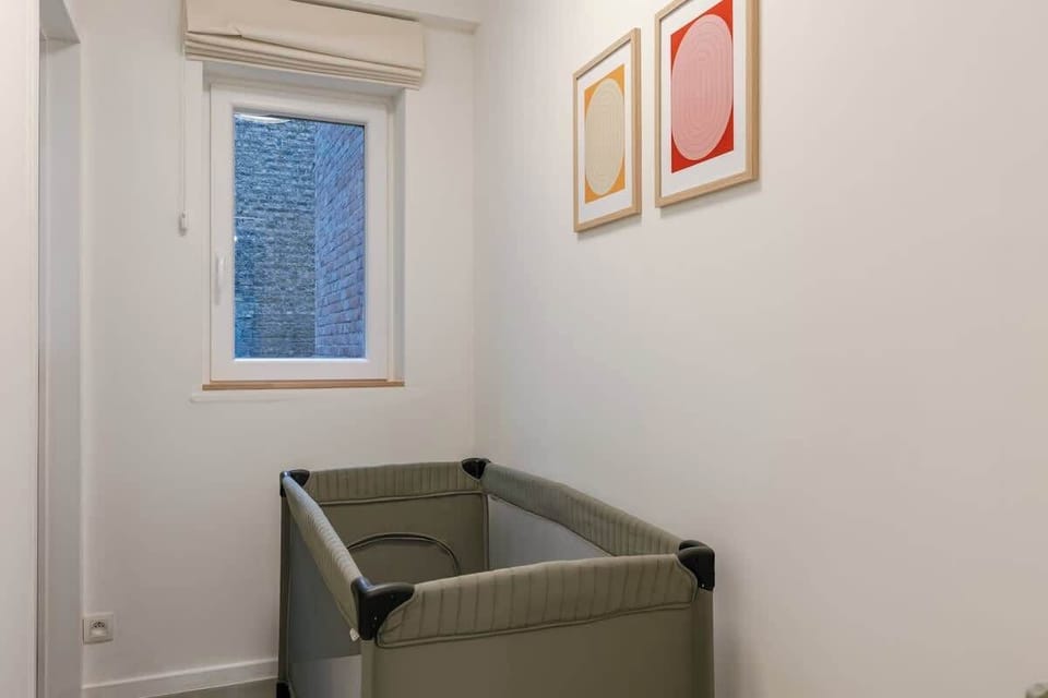 A unique, separate sleeping nook for babies or toddlers, featuring a travel cot and full blackout option.