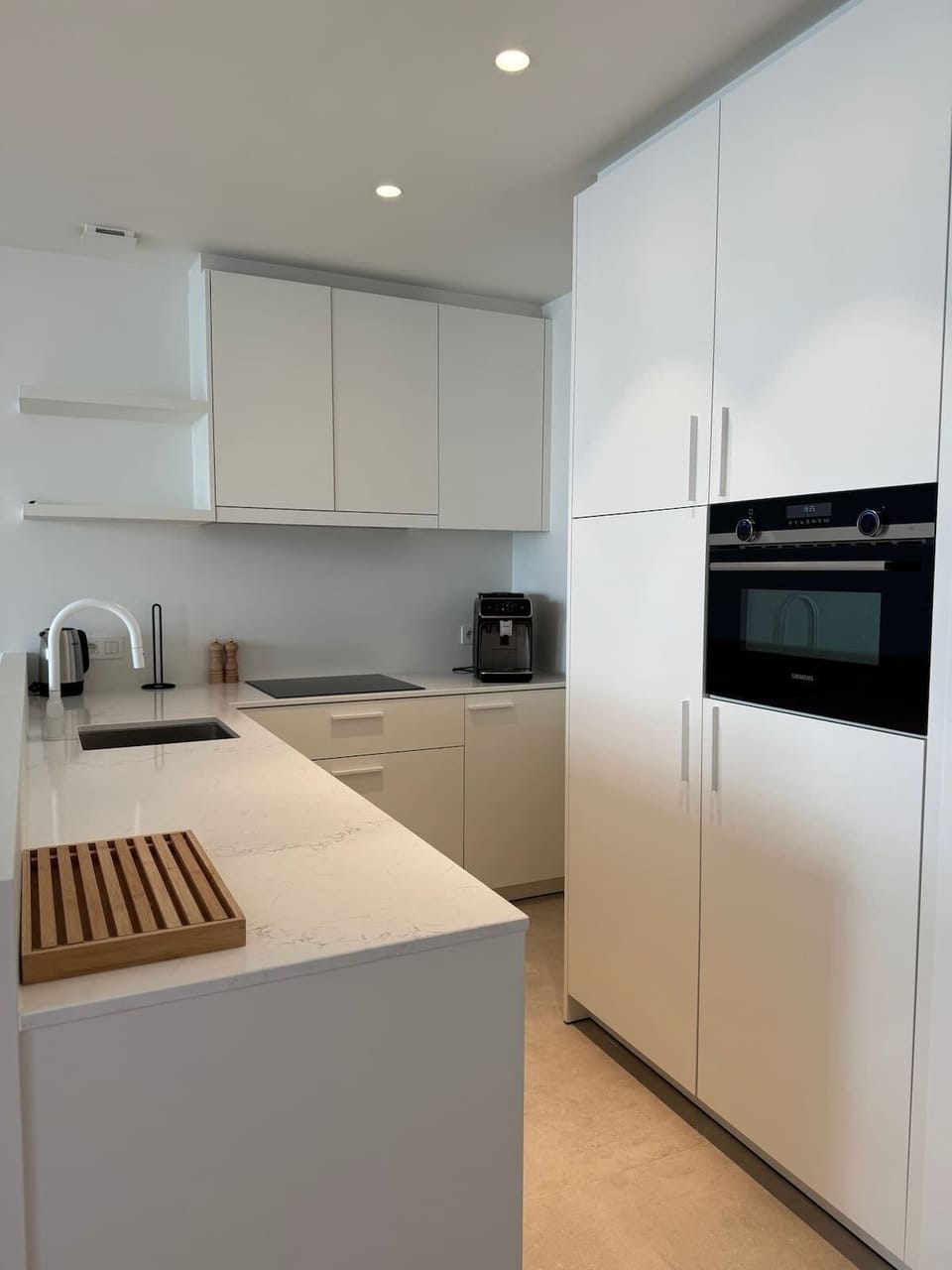 Fully Equipped Kitchen
Sleek modern kitchen with built-in appliances and cooking essentials.