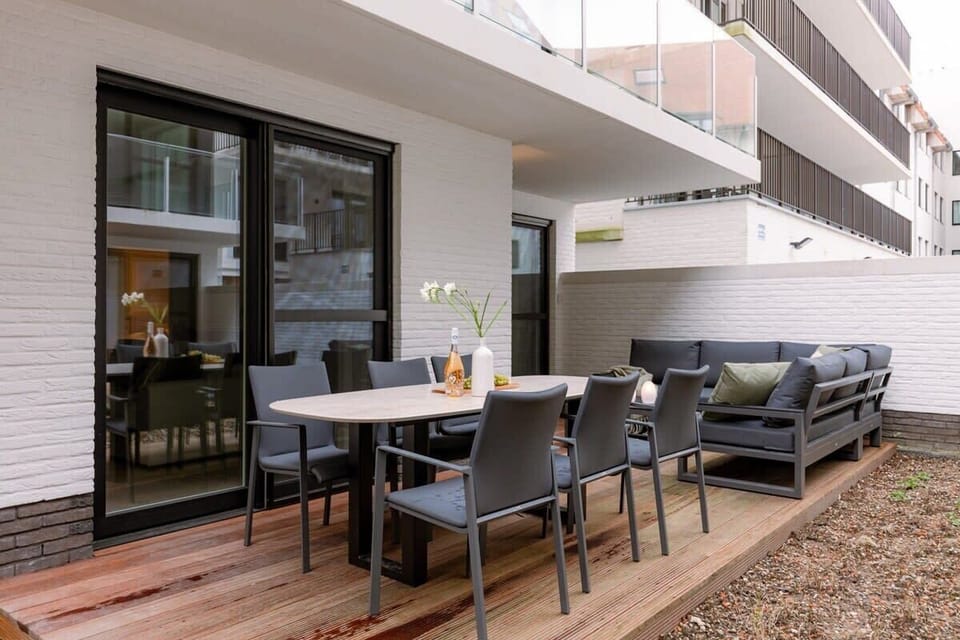 Modern outdoor patio with dining table and lounge seating for relaxing gatherings.
