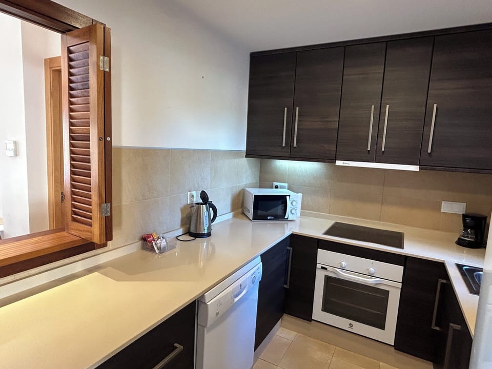 Fully equipped kitchen with microwave, oven, hob, dishwasher and washing machine