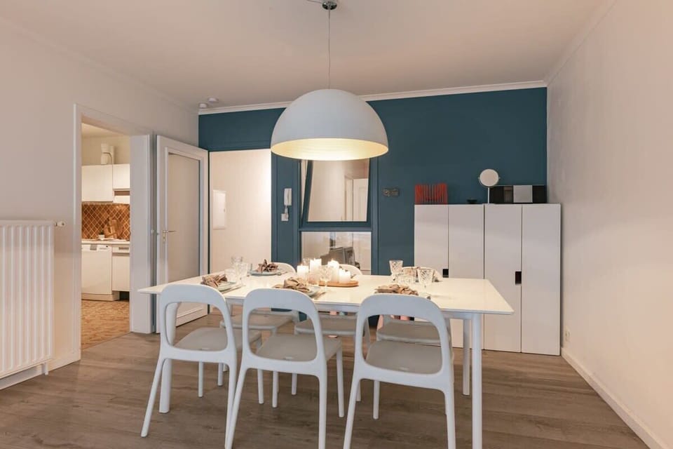 Dining table with access to the kitchen and both bedrooms