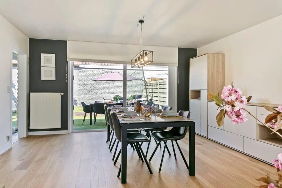 Modern dining area with seating for eight and garden access through sliding glass doors