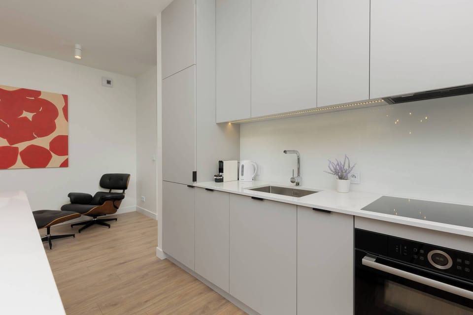 A contemporary kitchen with white cabinets, built-in appliances, and a clean, streamlined look.