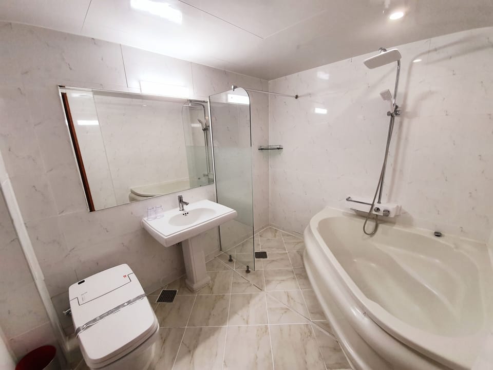 Deluxe Room | Bathroom | Combined shower/tub, deep soaking tub, designer toiletries, hair dryer