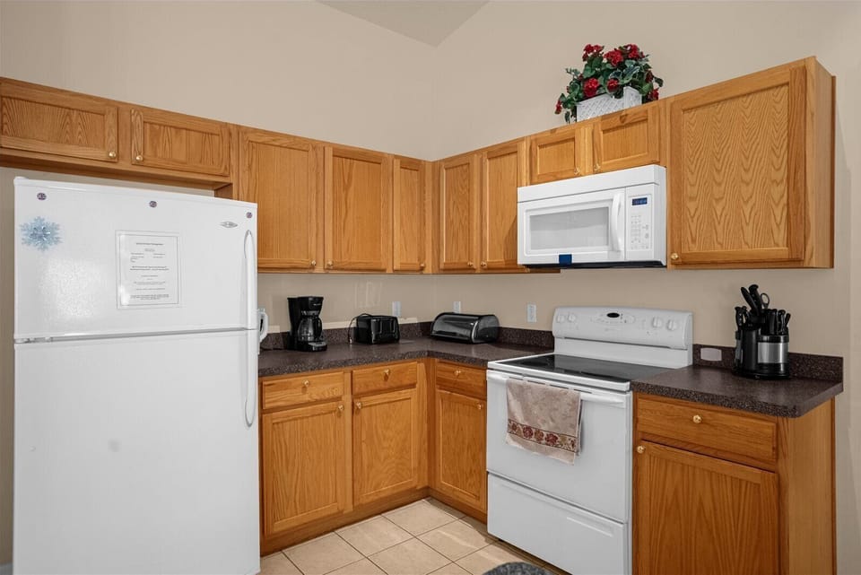 Kitchen with Fridge, Microwave, Stove, Toaster & Coffee Maker