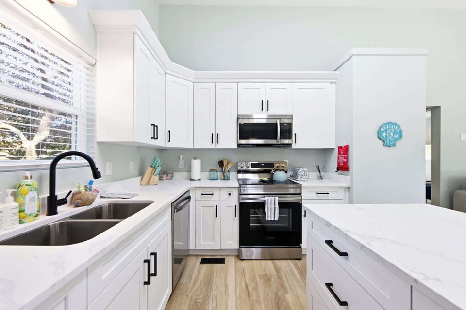 Fully equipped modern kitchen with quartz counters, natural light, and sleek finishes