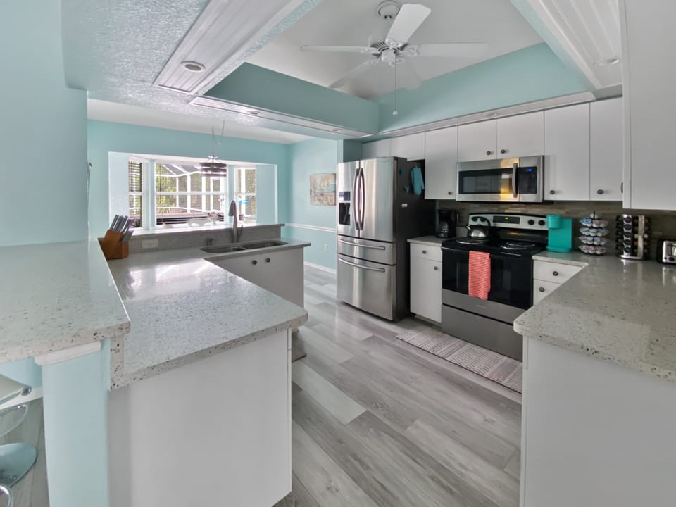 Modern kitchen with stainless steel appliances and a view of the patio.