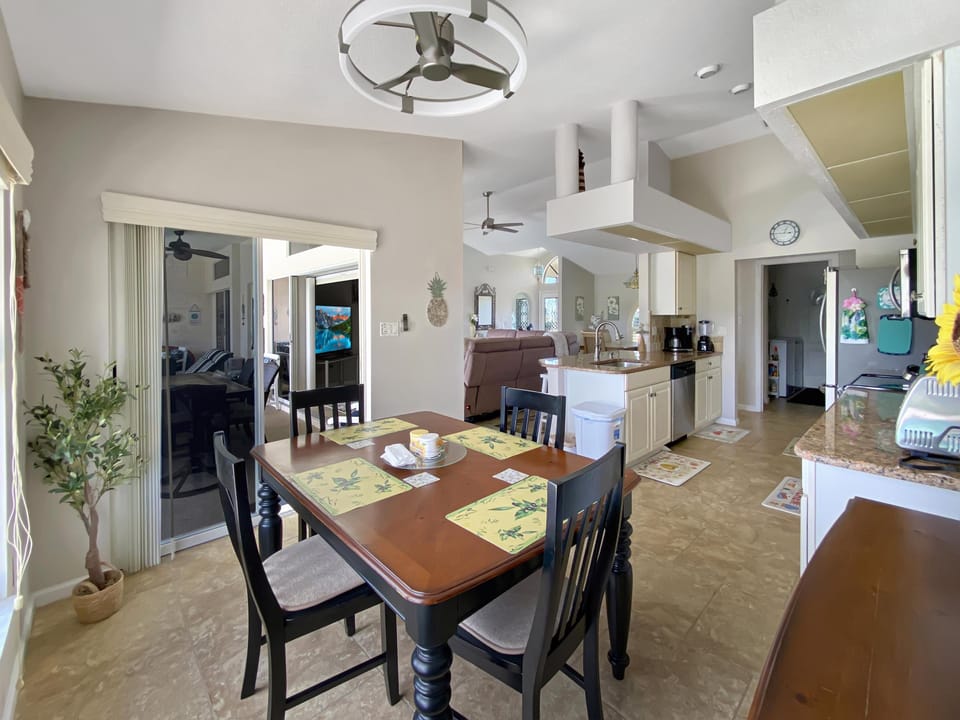 Open-concept kitchen and dining area with modern amenities and natural light.