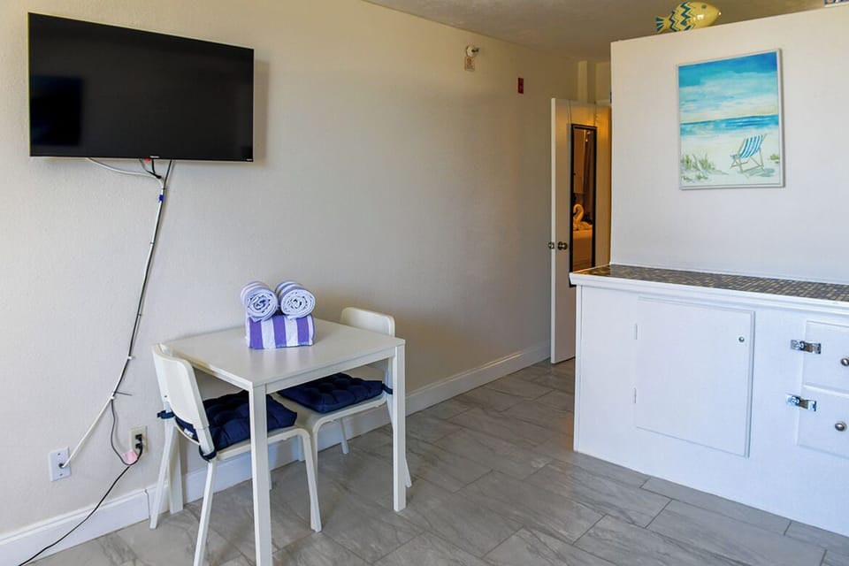 Relax at your cozy dining table while catching up on shows, with fresh towels ready for beach days ahead.