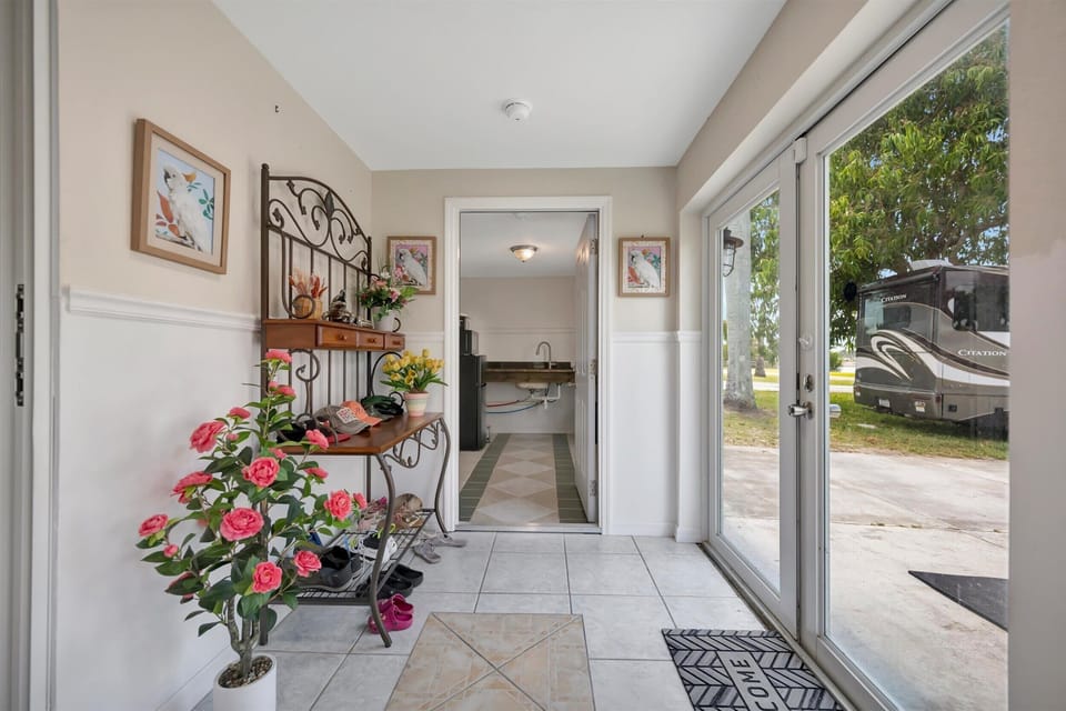 Bright entry sunroom with sliding doors and seating