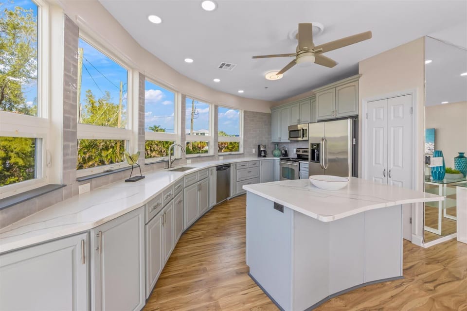 Full kitchen with island and stainless steel appliances