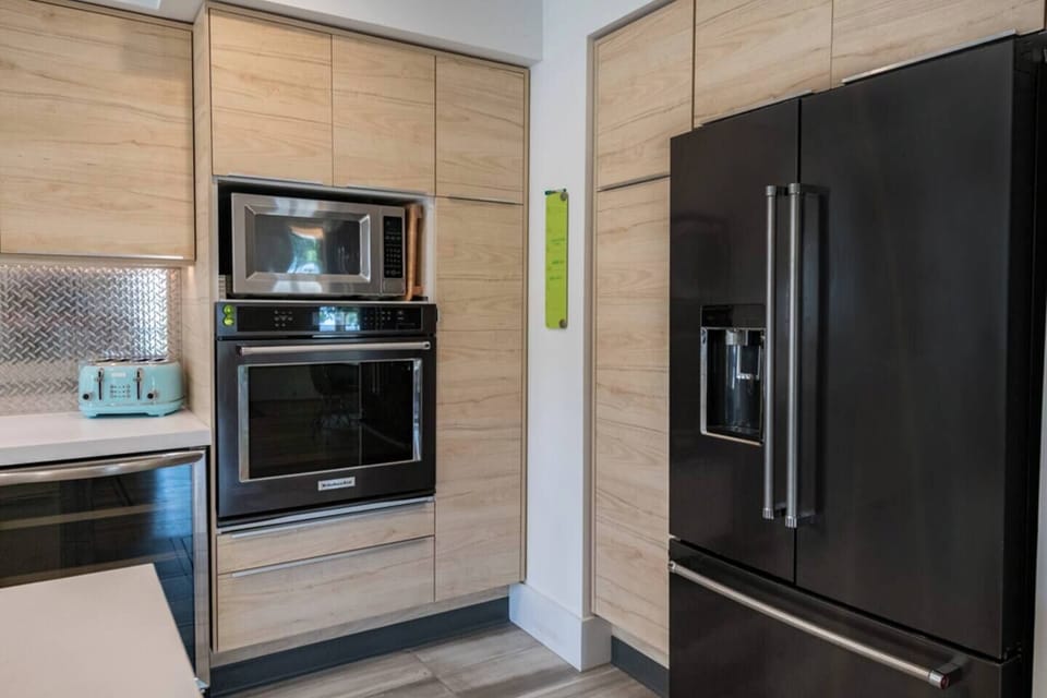 Kitchen appliances include refrigerator, microwave, wall oven, toaster, wine cooler, dishwasher, and gas cooktop.