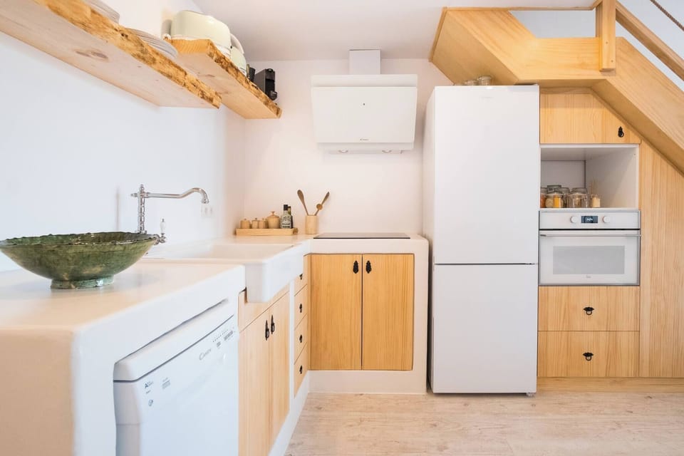 Fully equipped kitchen with oven, microwave, coffee maker, and utensils, ready for meal preparation