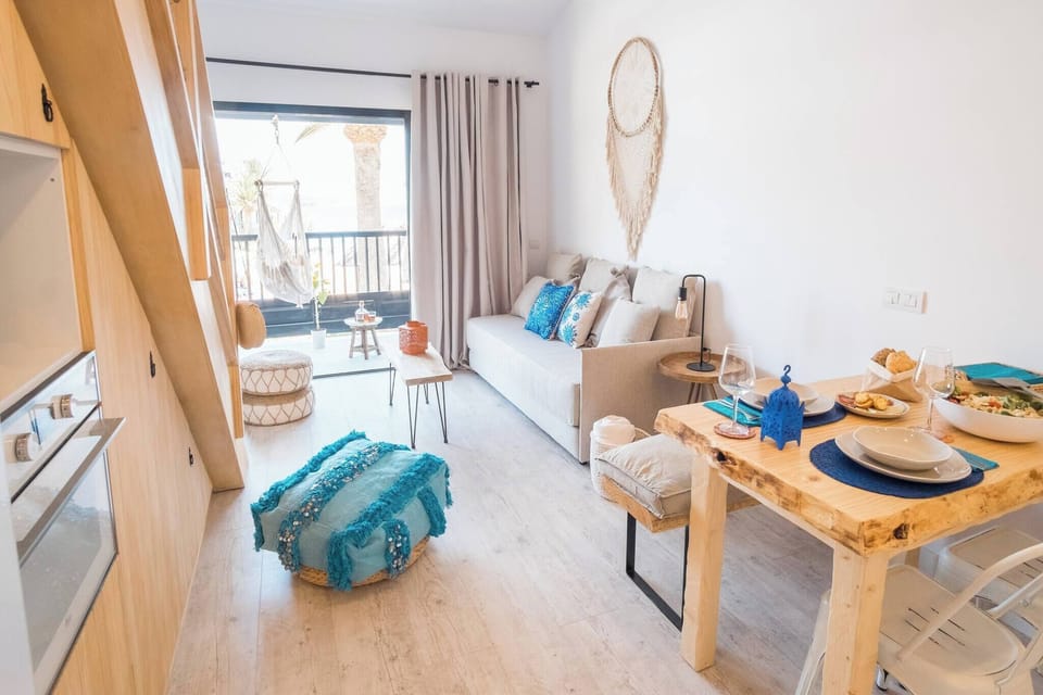 Living room with sofa and dining table, a bright and functional space to relax and enjoy meals