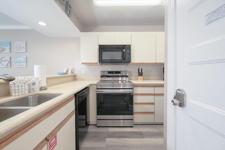 Full kitchen with updated appliances and stocked for basic needs!