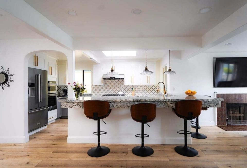 Open kitchen and bar seating—perfect for meals or casual work