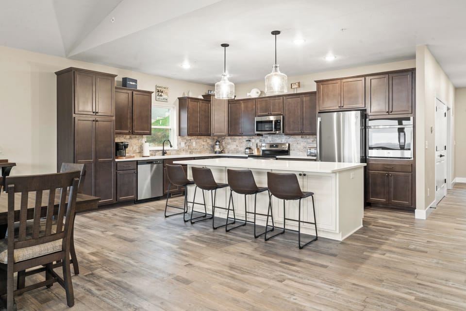 Fully stocked Kitchen has (2) dishwashers, (1) microwave, slide in range with oven, (1) wall oven, large refrigerator/freezer with ice maker. The island seats four.