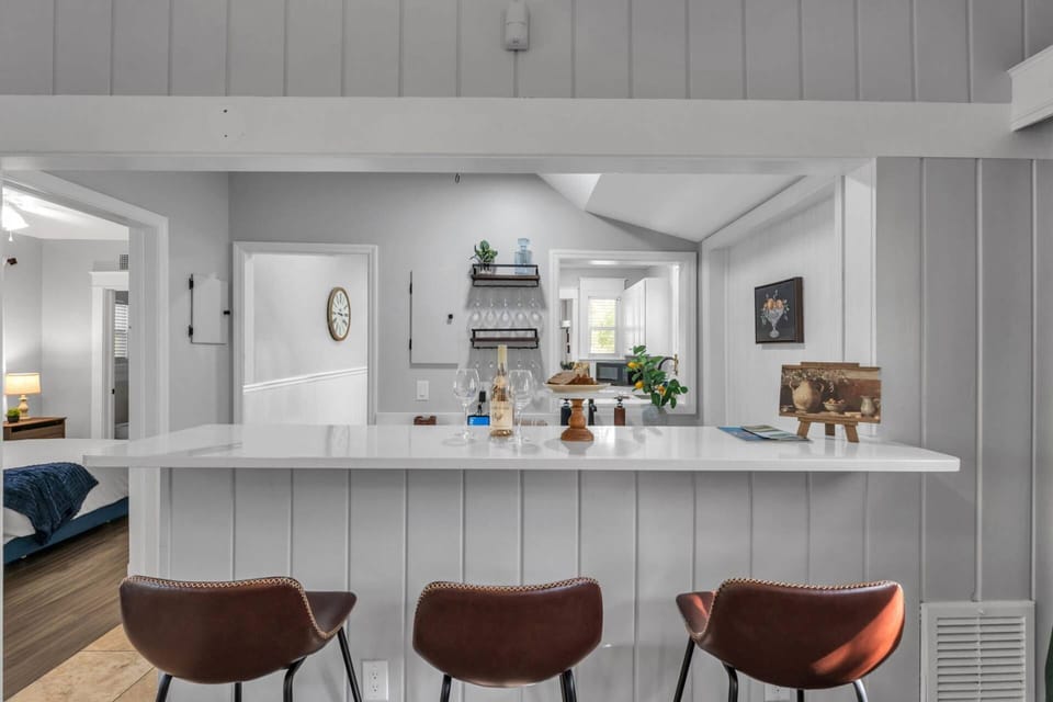 Fully equipped kitchen with breakfast bar seating—great for cooking, coffee, and casual meals.