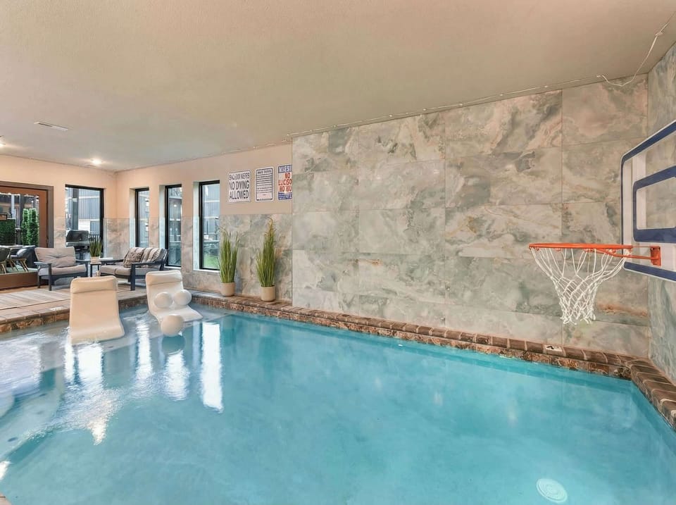 Indoor pool w/ stone accents & spacious seating areas for year-round relaxation
