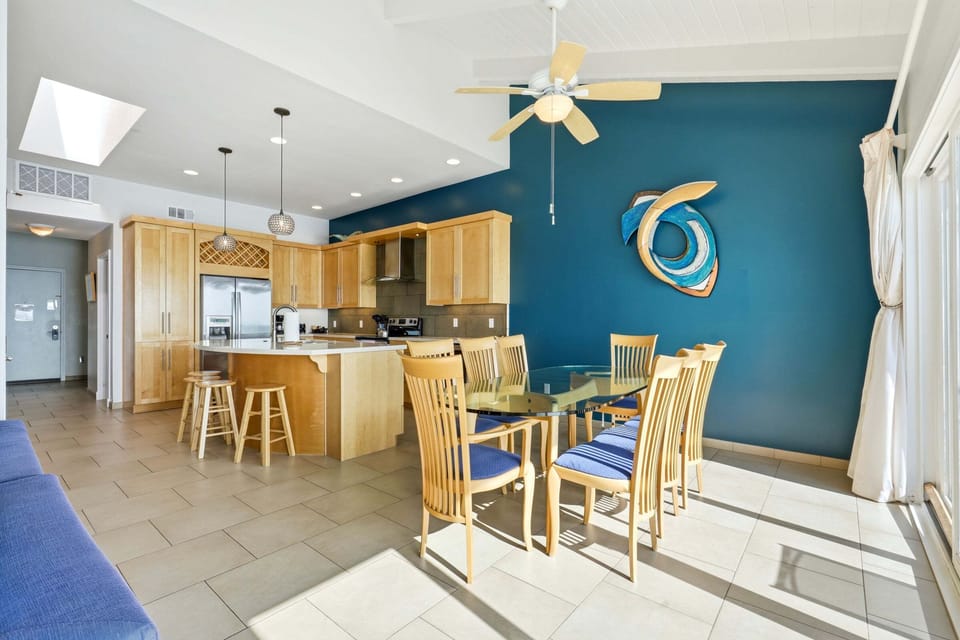 Open-concept kitchen and dining area with coastal design