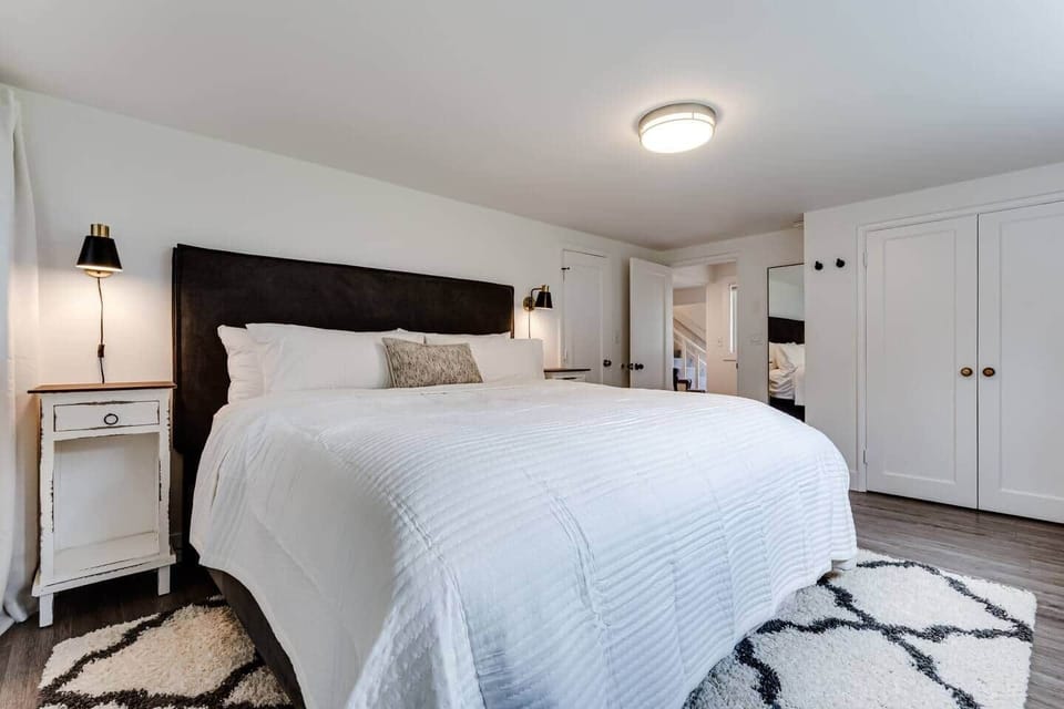 Master bedroom downstairs with King bed and black out curtains