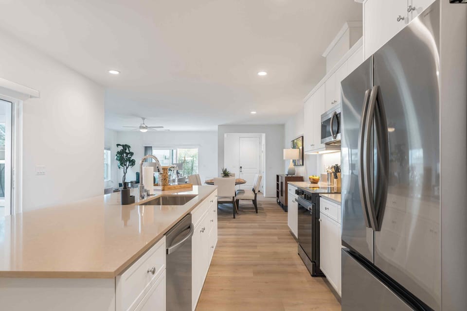 Your gourmet kitchen awaits, featuring an expansive island and premium Caesarstone countertops.