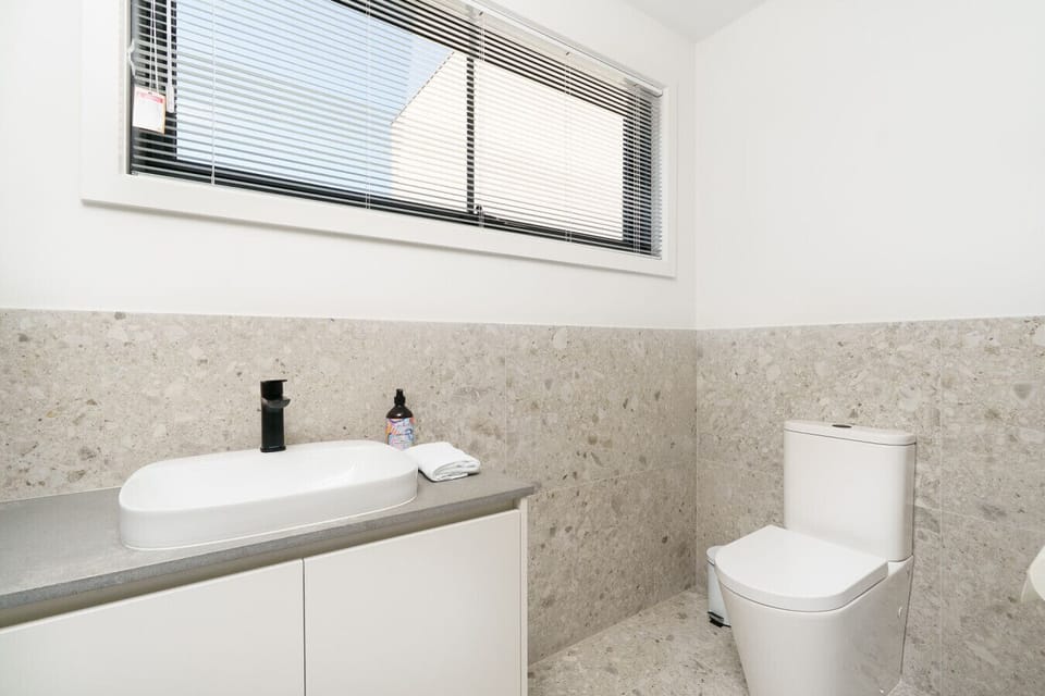 A neat and bright powder room that adds comfort and convenience to your stay.