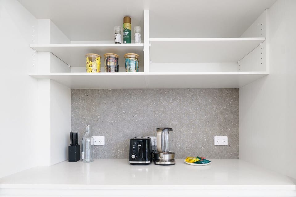 Thoughtful open shelving stocked with essentials to make your stay comfortable and stress-free.
