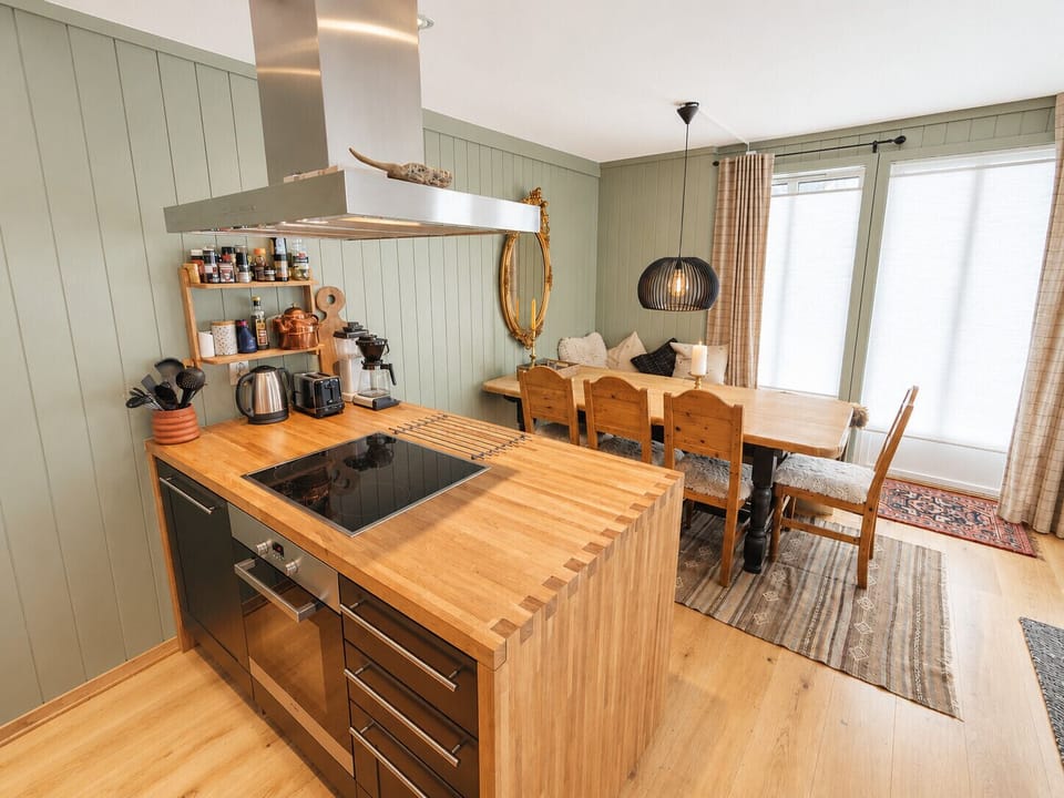 Fully equipped kitchen with cooking essentials and comfortable dining space with seating for whole family