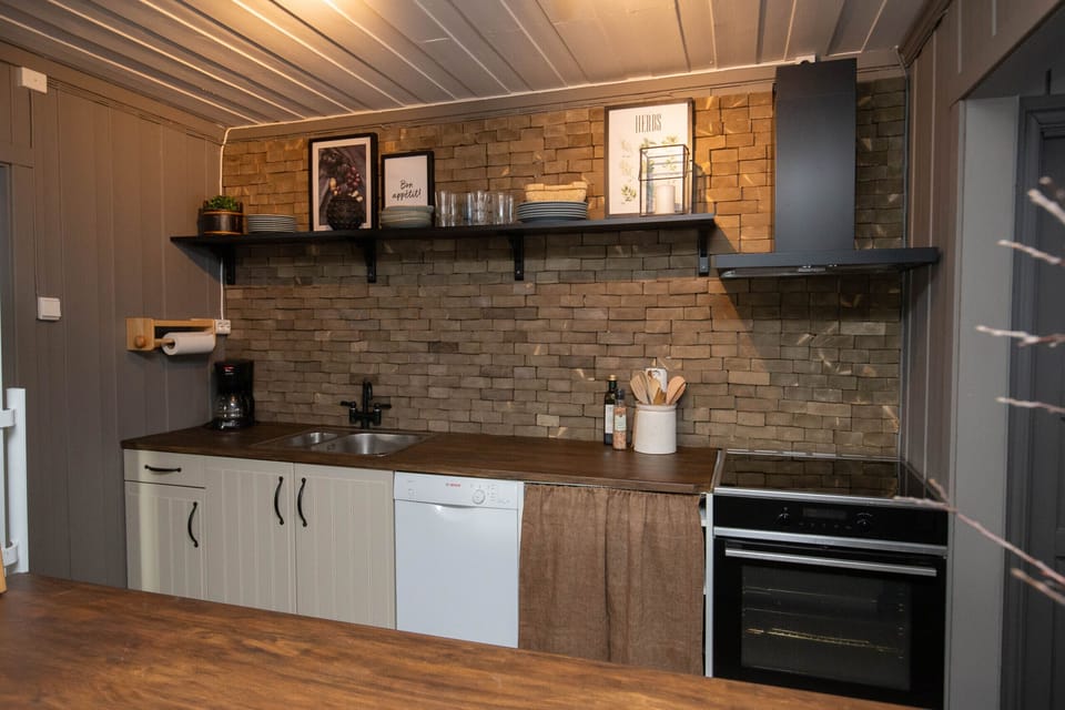 Modern kitchen with stove, oven, and plenty of counter space, ideal for home-cooked meals.