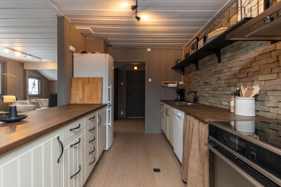 Modern kitchen with stove, oven, and plenty of counter space, ideal for home-cooked meals.