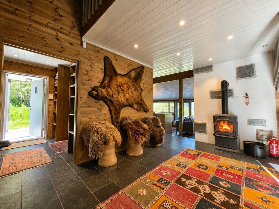 Cozy seating area with sheep skin stools and a fireplace