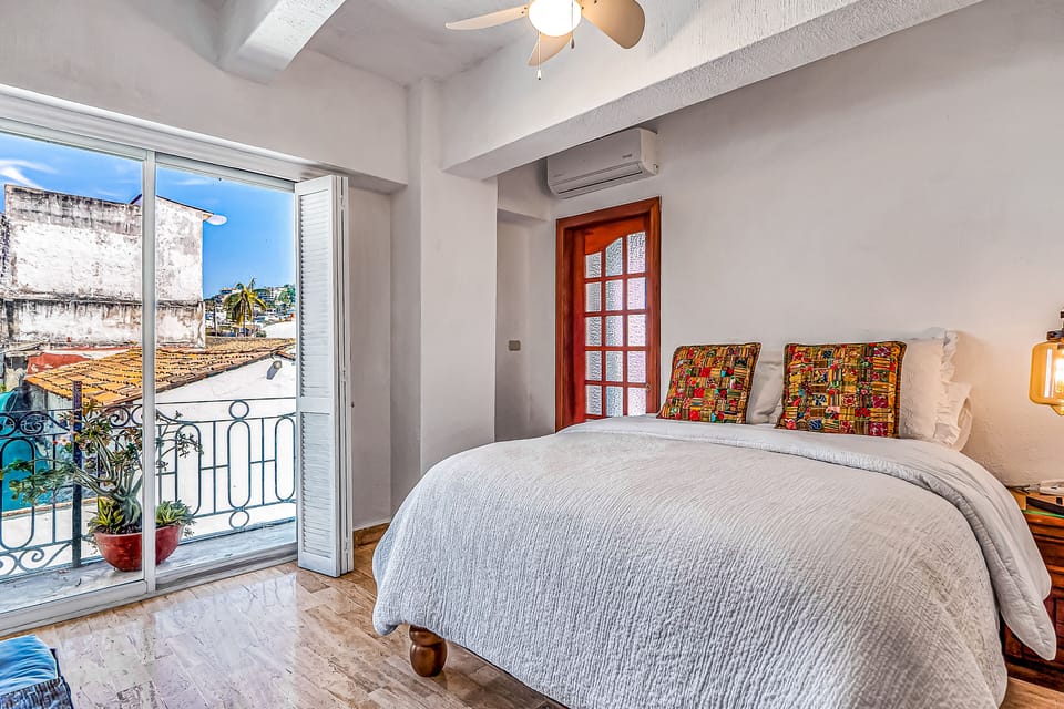 Wake up to charming city views! This bright, air-conditioned bedroom features large glass doors that open to a lovely Juliet balcony letting in the fresh breeze.
