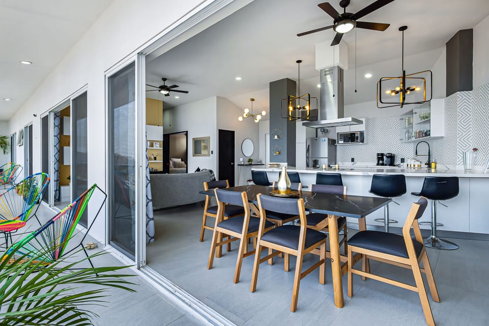 Dining Area with a View
Stylish dining table set beside expansive glass doors, offering breathtaking ocean views while you enjoy meals or morning coffee in natural light