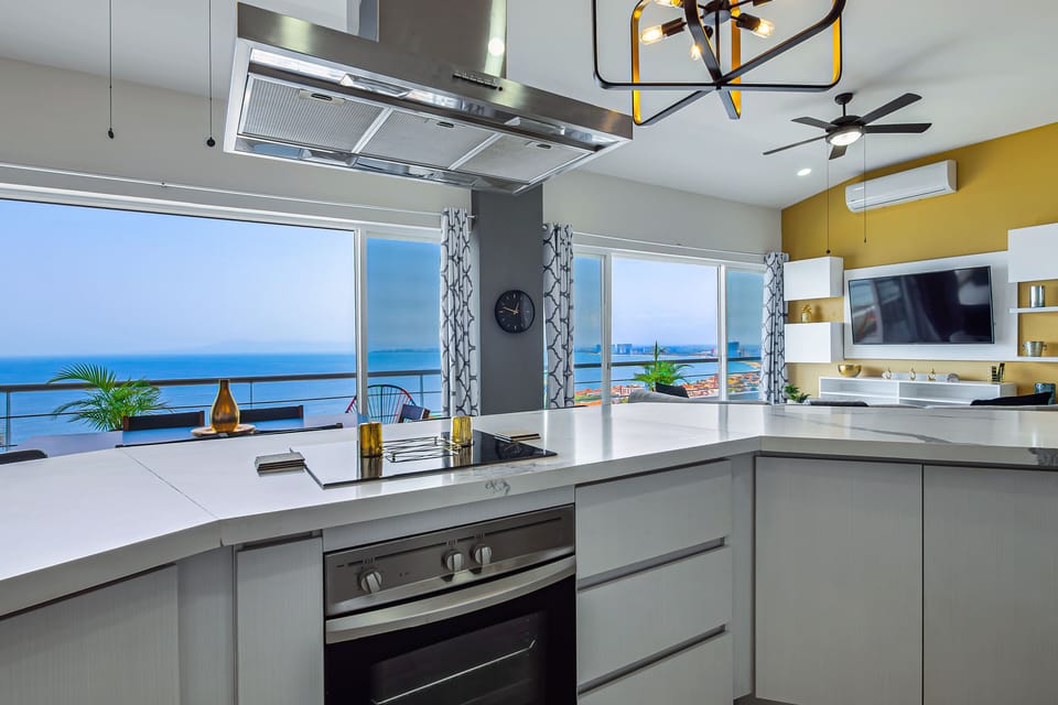 Fully equipped kitchen with sleek countertops, stainless steel appliances, and a spacious island with bar seating—perfect for cooking, entertaining, and gathering.