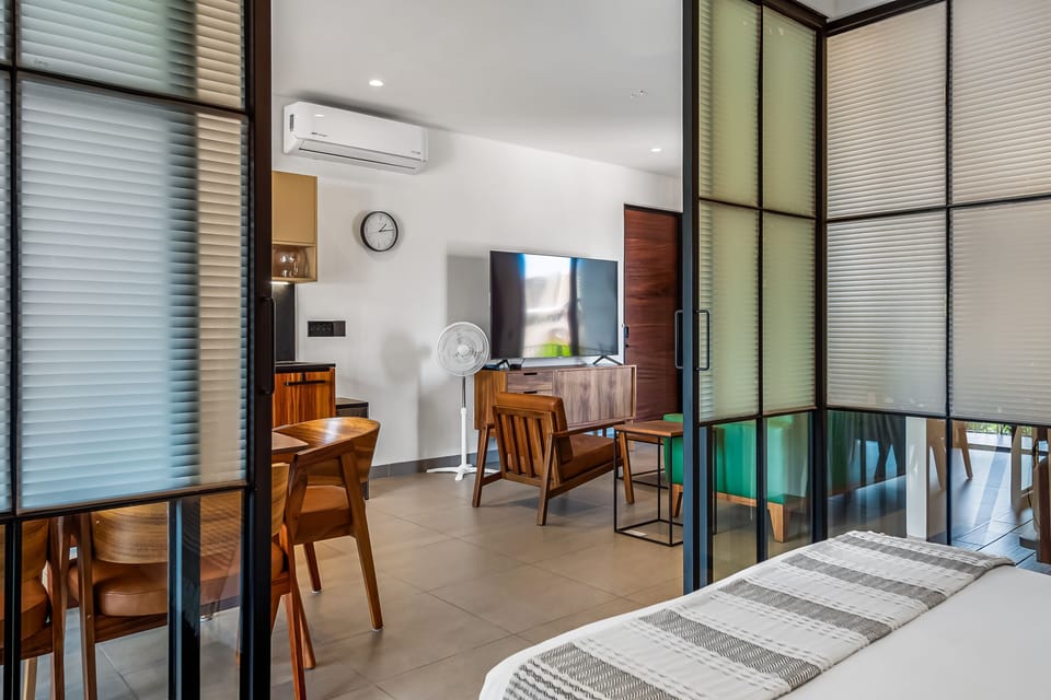 Slide open the privacy doors to enjoy a seamless connection from the bedroom to the bright, spacious living and kitchen areas.