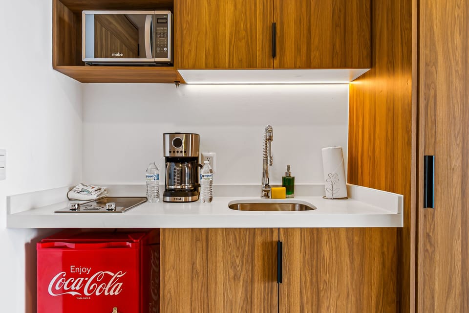 Beautifully designed kitchenette with modern finishes, perfect for preparing coffee, light meals, and enjoying the comfort of a home away from home.