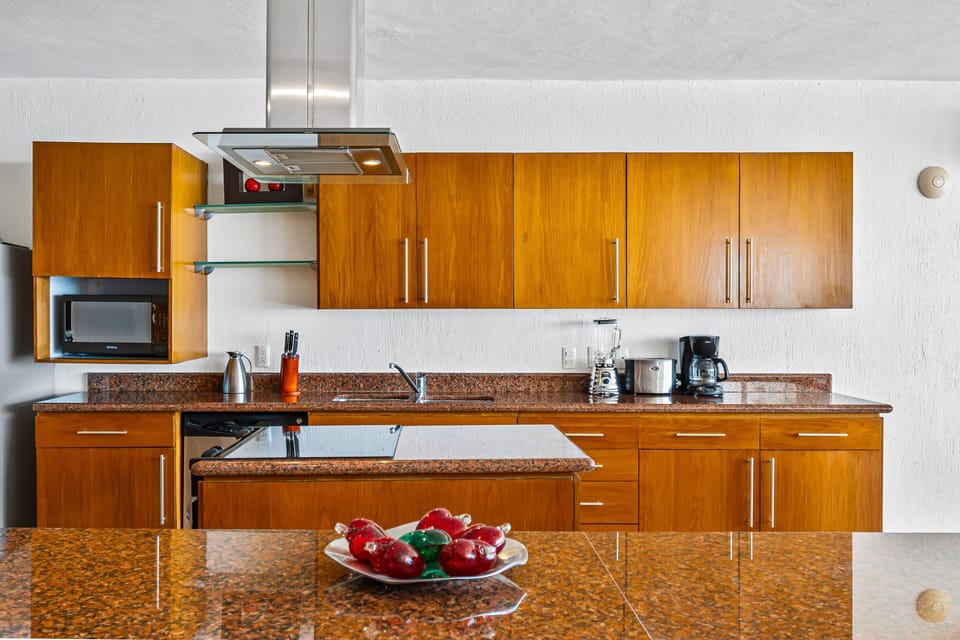 Fully equipped kitchen with granite countertops, modern appliances, and a spacious island for cooking and entertaining.